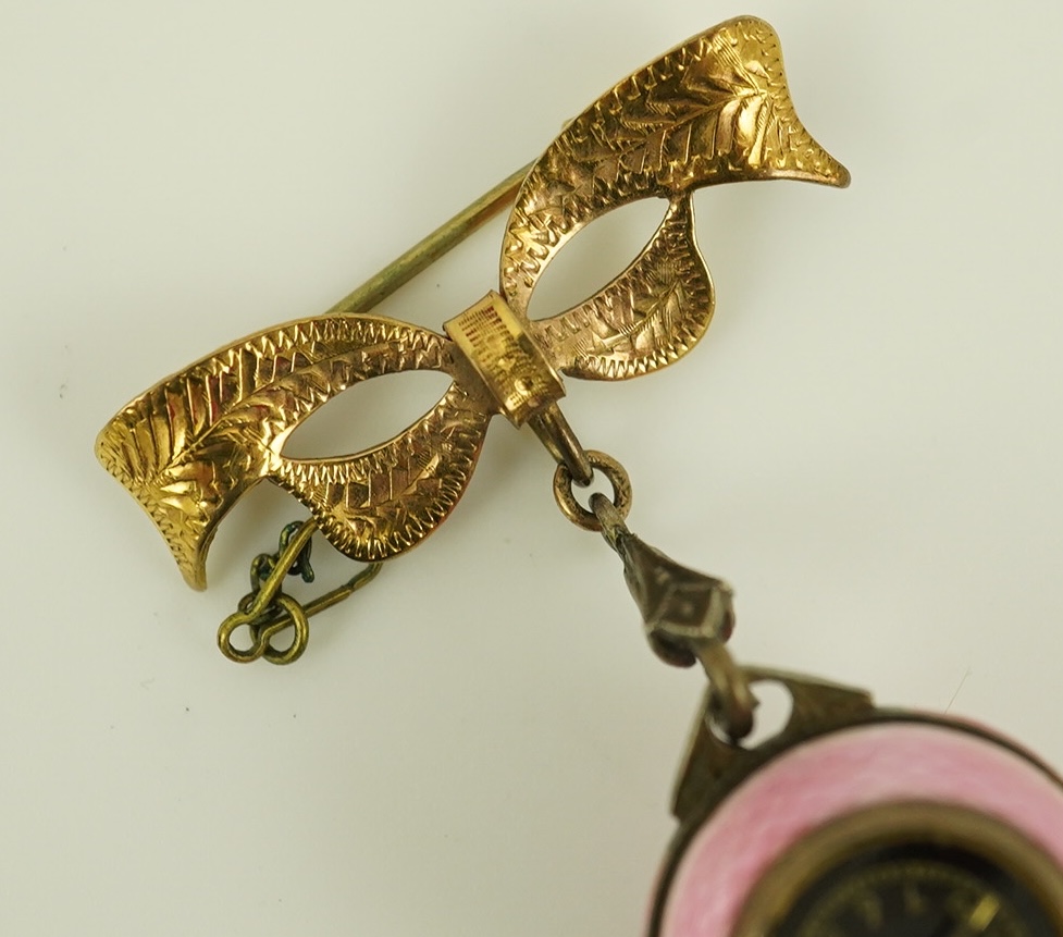 An early to mid 20th century silver and pink guilloche enamel Burger manual wind globe lapel watch, on a later 9ct gold ribbon bow suspension brooch